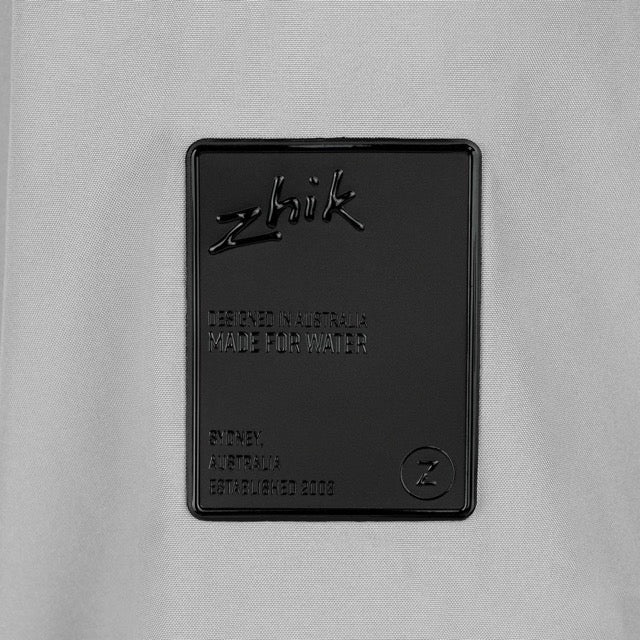 Black Zhik logo on a gray fabric background