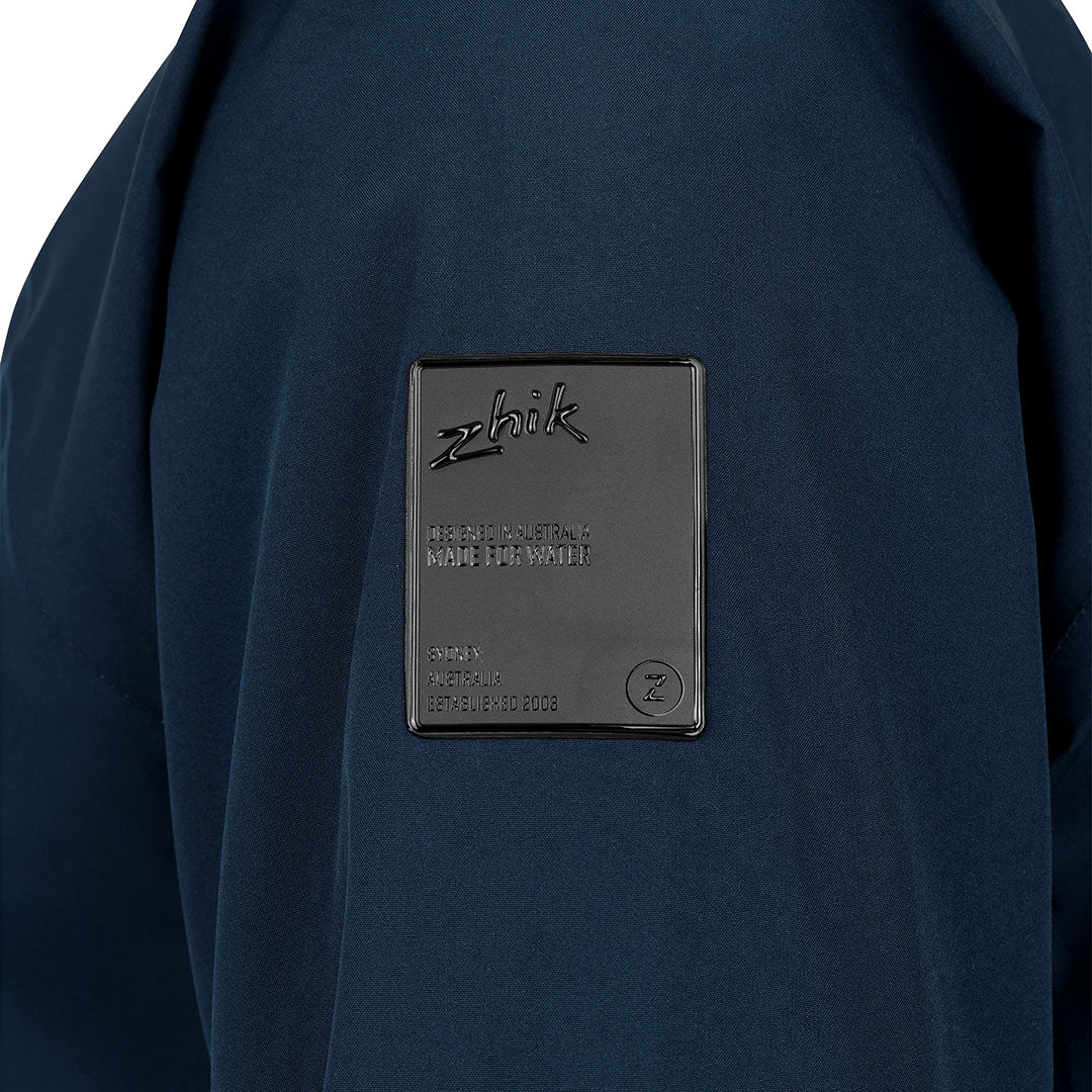 Close-up of a navy blue jacket with Zhik branding on a white background