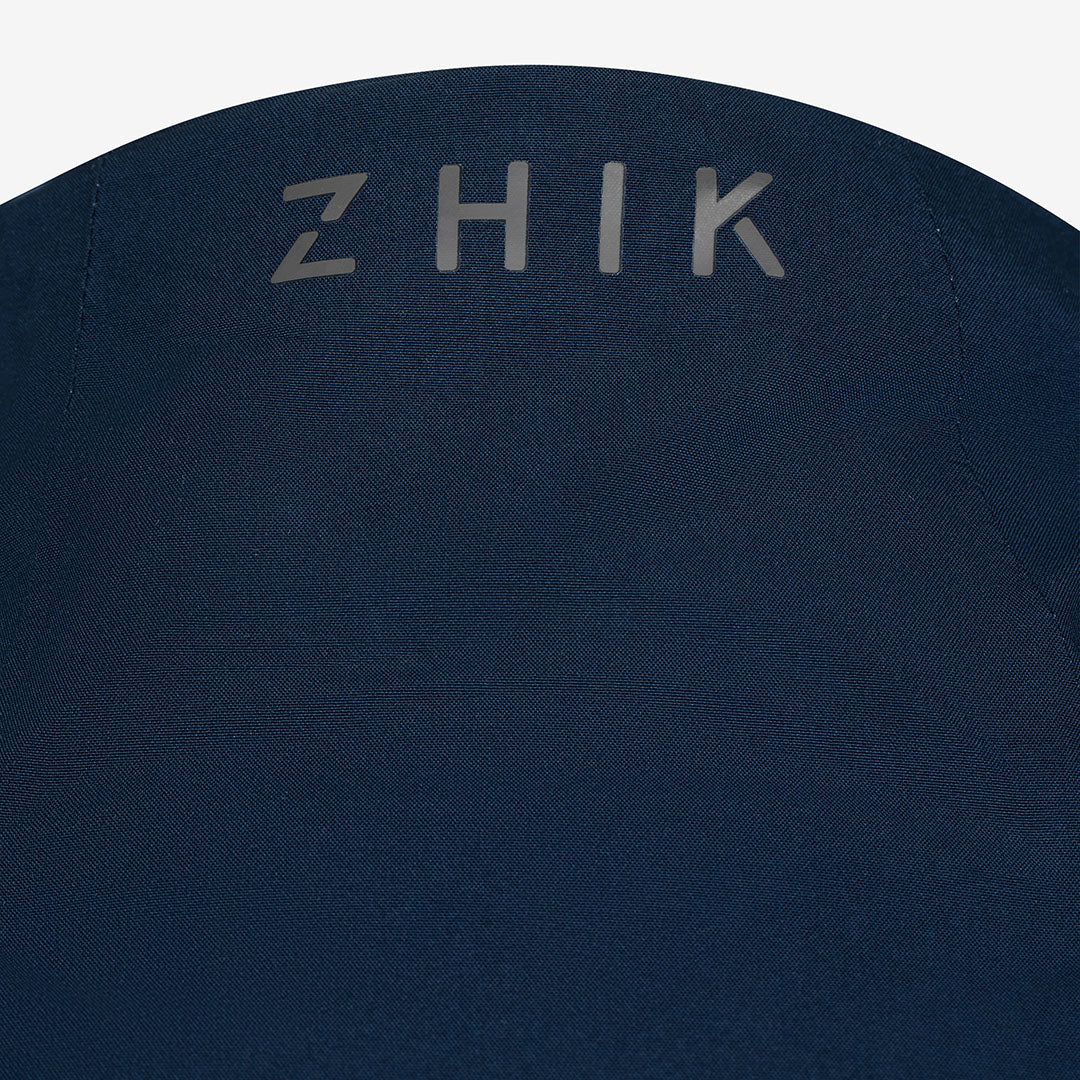 Navy blue jacket with 'ZHIK' branding on a white background